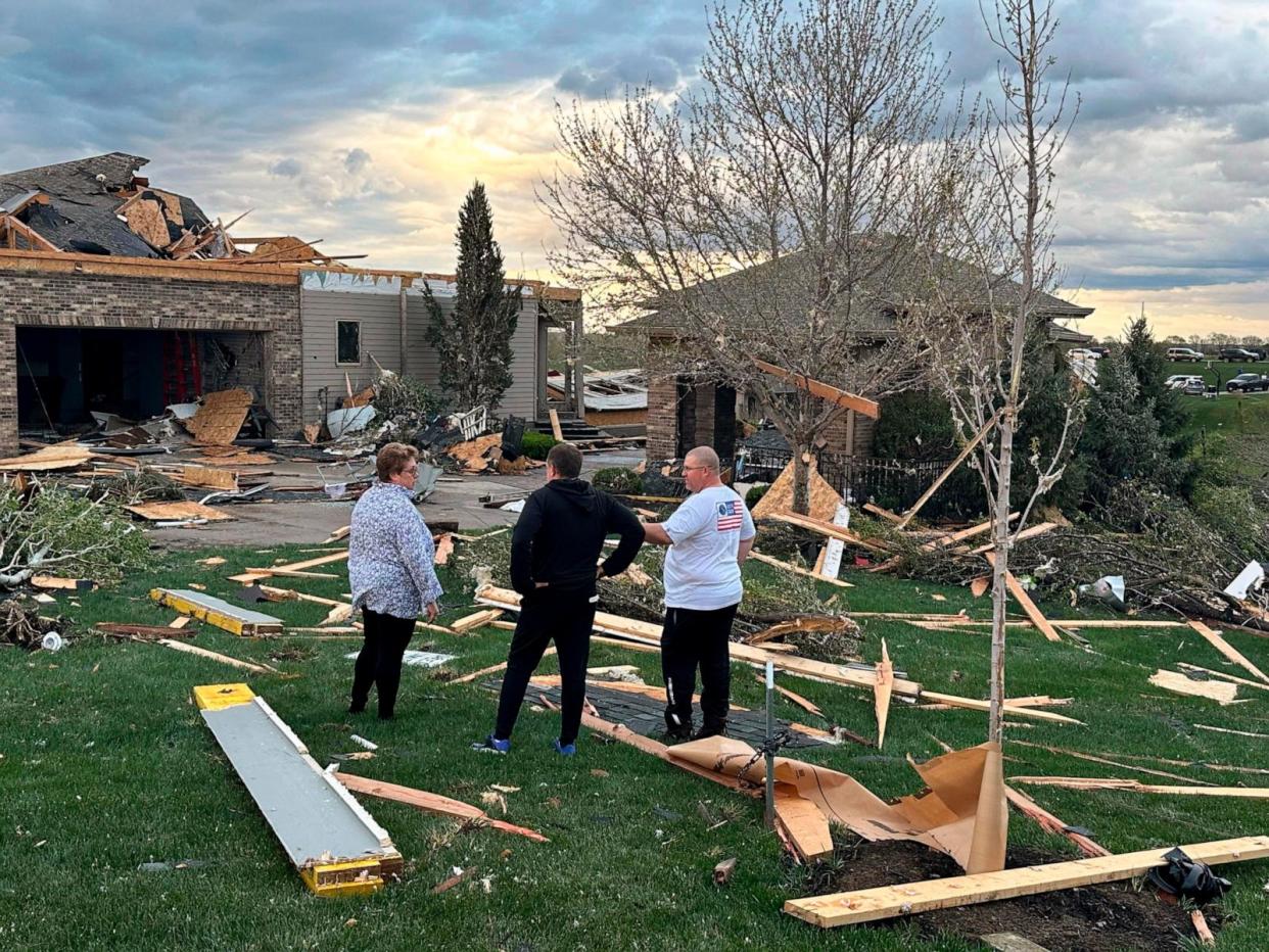 PHOTO: Homeowners assess damage after a tornado caused extensive damage in their neighborhood northwest of Omaha, in Bennington, Neb., on April 26, 2024. (Josh Funk/AP)