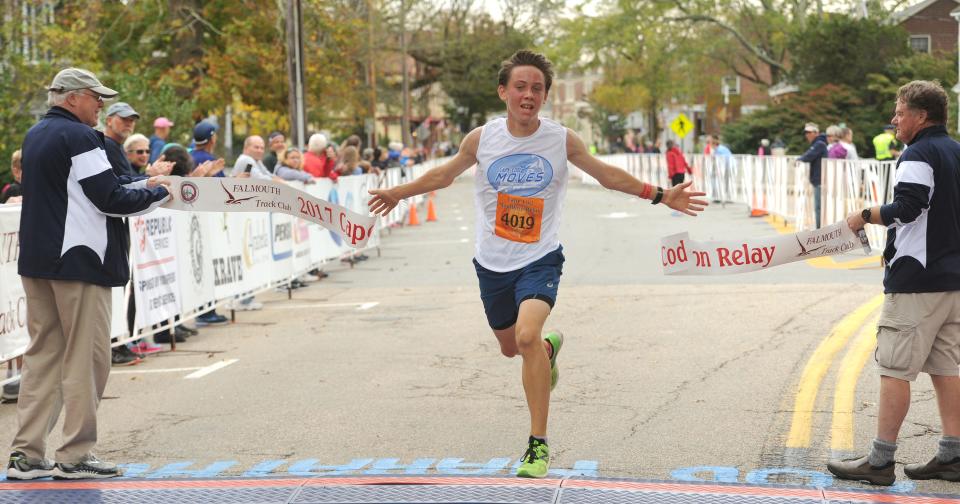 In this October 2017 photo, Falmouth resident Caleb Gartner of the Cape Cod Moves relay team crosses over the finish line first for the men's relay in the Cape Cod Marathon. This year's marathon will be the weekend of Oct. 7-8.