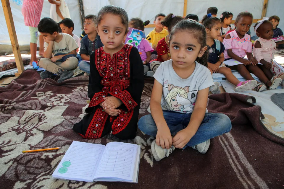 Palestinian students attend a class in a tent set up on the rubble of the house of teacher Israa Abu Mustafa, as war disrupts a new school year, amid the Israel-Hamas conflict, in Khan Younis, in the southern Gaza Strip, September 4, 2024.