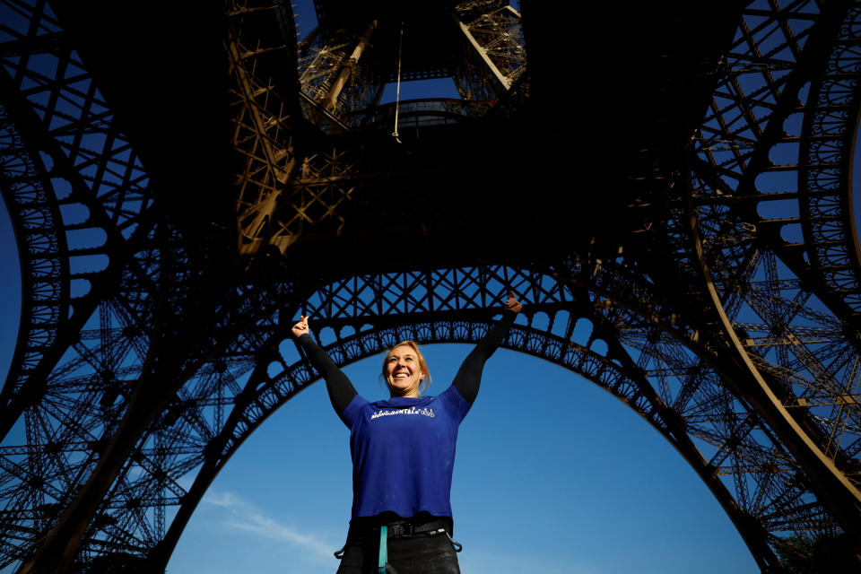 Athlete and Olympics torch bearer Anouk Garnier celebrates after climbing a 110-meter-long rope launched in the center of the Eiffel Tower square to reach the 2nd floor and breaking the world record for rope climbing, in Paris, France, April 10, 2024. / Credit: Sarah Meyssonnier / REUTERS