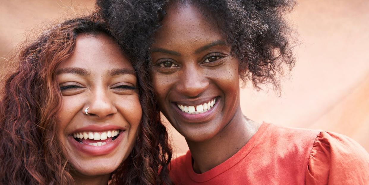 two young woman smiling to camera