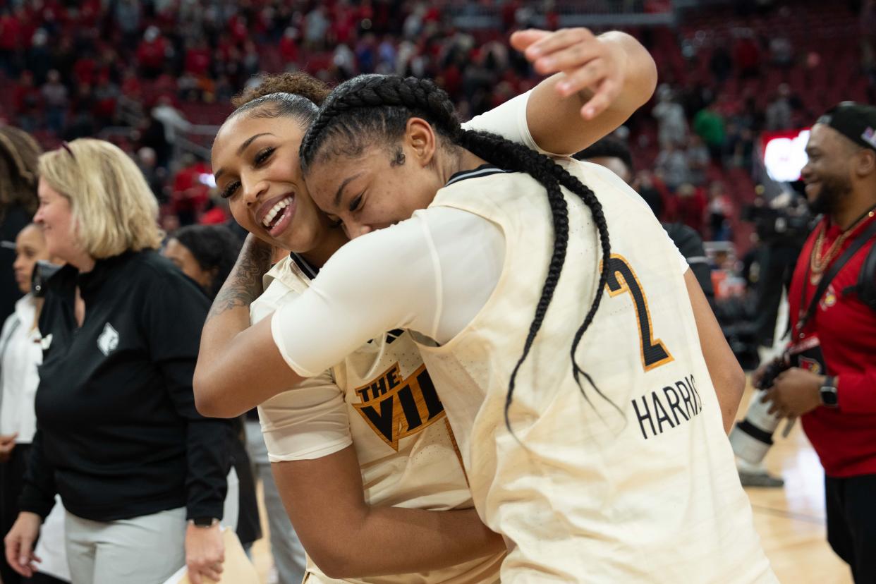 Louisville guard Sydney Taylor celebrates with forward Nyla Harris. Harris scored a career-high 19 points in the Cardinals' home victory over Notre Dame on Thursday night.