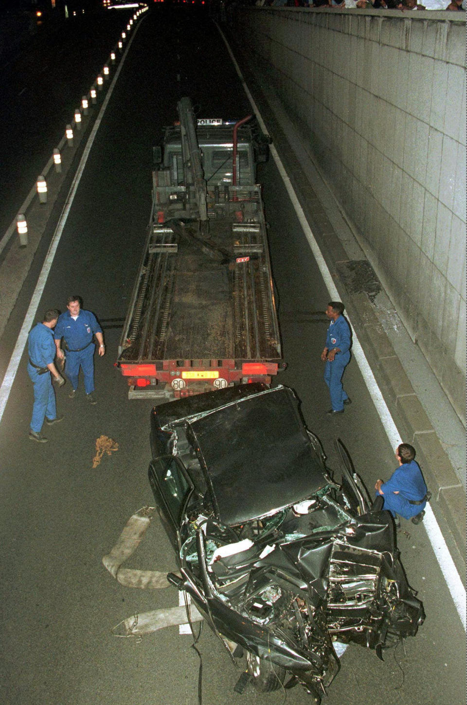 FILE - Police services take away the car in which Diana, Princess of Wales, was seriously injured early Sunday, Aug. 31, 1997 in Paris, in a crash that killed her boyfriend, Dodi Fayed, and the driver. The story of Princess Diana's death at age 36 in that catastrophic crash in a Paris traffic tunnel continues to shock, even a quarter-century later. (AP Photo/Jerome Delay, File)