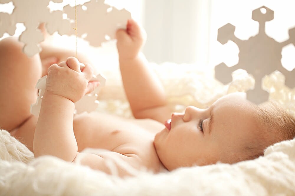 baby playing with snowflakes