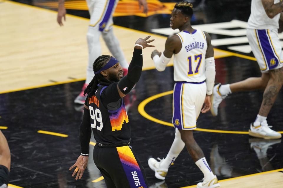 Phoenix Suns forward Jae Crowder (99) celebrates his three-point basket as Los Angeles Lakers guard Dennis Schroder (17) looks on during the first half of Game 1 of their NBA basketball first-round playoff series Sunday, May 23, 2021, in Phoenix. (AP Photo/Ross D. Franklin)