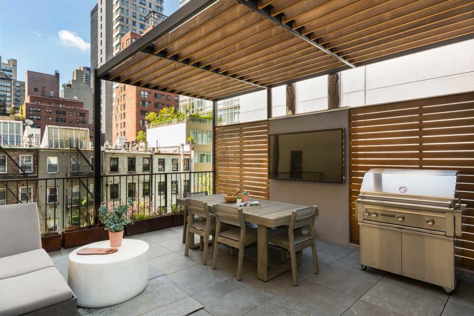 an outdoor terrace with a privacy screen