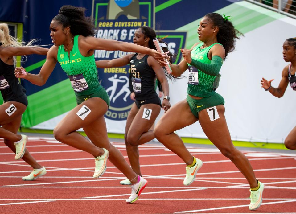 Oregon's Jasmin Reed hands the baton to teammate Jasmine Montgomery in the semifinal round of the women's 4x100 meter relay on the second day of the NCAA Outdoor Track & Field Championships Thursday, June 9, 2022 at Hayward Field in Eugene, Ore.