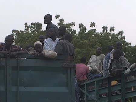 Former Nigerian hostages held by Boko Haram who were freed by the Cameroonian military arrive in Maroua, Cameroon, in this still image taken from a December 5, 2015 video footage. REUTERS/Reuters TV