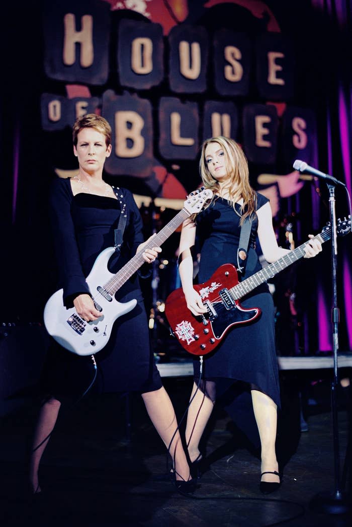 Jamie Lee Curtis and Lindsay Lohan play guitar on stage at the House of Blues and wear elegant black dresses