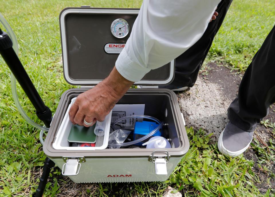 Manuel Aparicio IV, a board member of the Calusa Waterkeeper non-profit organization, demonstrates a portable air filter he helped develop to check the air for algal toxins during an interview at the W.P. Franklin South Recreation Area Thursday, July 1, 2021.