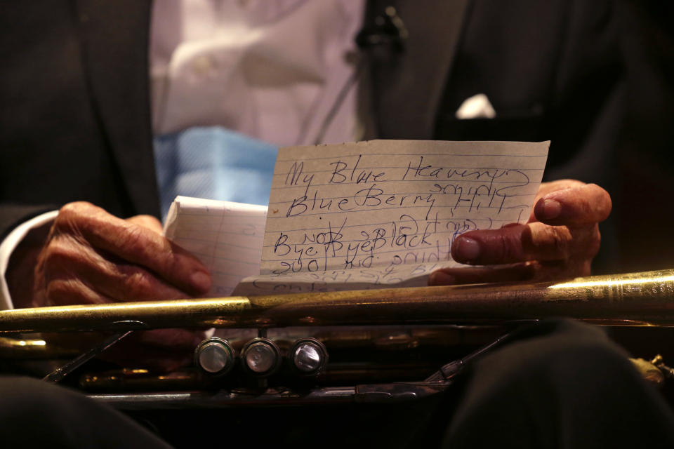 Venerable Dixieland jazz musician Lionel Ferbos reads his notes as he performs at his 102nd birthday party at the Palm Court Jazz Cafe in New Orleans, Wednesday, July 17, 2013. Ferbos, who bought his first cornet at a Rampart Street pawn shop when he was 15, is believed to be the oldest actively working musician in the city. His body isn’t without signs of age. He’s been in and out of the hospital in recent years and had a pacemaker implanted last year. He sometimes uses a wheelchair to get around, but he remains determined to sing and blow. (AP Photo/Gerald Herbert)