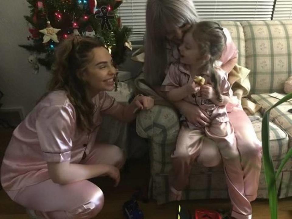 Courtney Wickman, right, and laughs with her daughter Lana and sister Samantha Wickman, left, in their matching pink pajamas. Courtney loved Barbie and filled her home with girly, pink decorations.