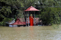A flooded Buddhist temple is seen on the side of a flooded road in Bulathsinhala village, in Kalutara, Sri Lanka May 27, 2017. REUTERS/Dinuka Liyanawatte
