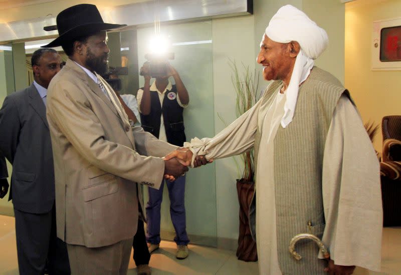 FILE PHOTO: First Vice President Salva Kiir welcomes former prime minister Al-Sadiq Al-mahdi in Khartoum