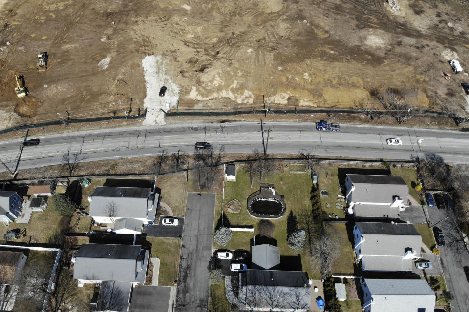 A plot of land that is being developed into multifamily housing, top, is seen in East Northport, N.Y., Thursday, March 16, 2023. Some elected officials from Long Island claim their suburban way of life is threatened by New York Gov. Kathy Hochul's plan to spur more housing construction. They claim it would swamp the area with new apartment buildings and turn it into a "sixth borough" of the city. (AP Photo/Seth Wenig)