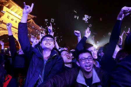 Supporters of Freddy Lim, a candidate to the 2016 legislative election and singer of death metal band Chthonic, take part during a concert to boost Lim's campaign in Taipei, Taiwan, December 26, 2015. REUTERS/Pichi Chuang