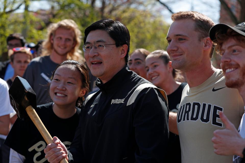 Purdue President Mung Chiang poses for a photo with students during the Purdue Day of Giving event, Wednesday, April 26, 2023, at Purdue's Memorial Mall in West Lafayette, Ind.