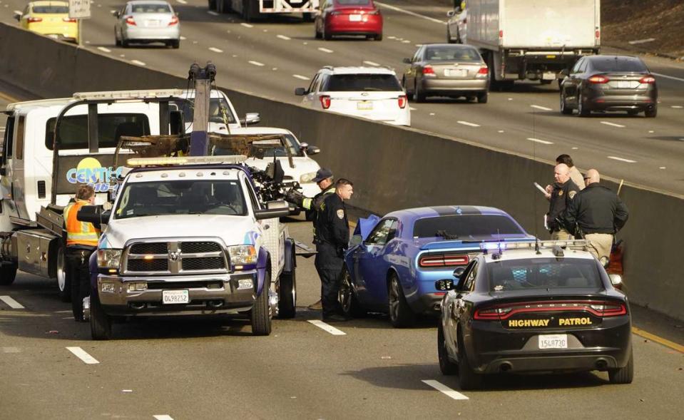 An Elk Grove police officer riding a motorcycle was killed Friday morning after being struck by a man, driving the blue car, center, the wrong way on southbound Highway 99 in Sacramento.