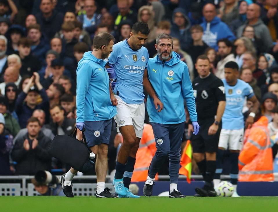 Rodri is helped from the field by City physios (Reuters)