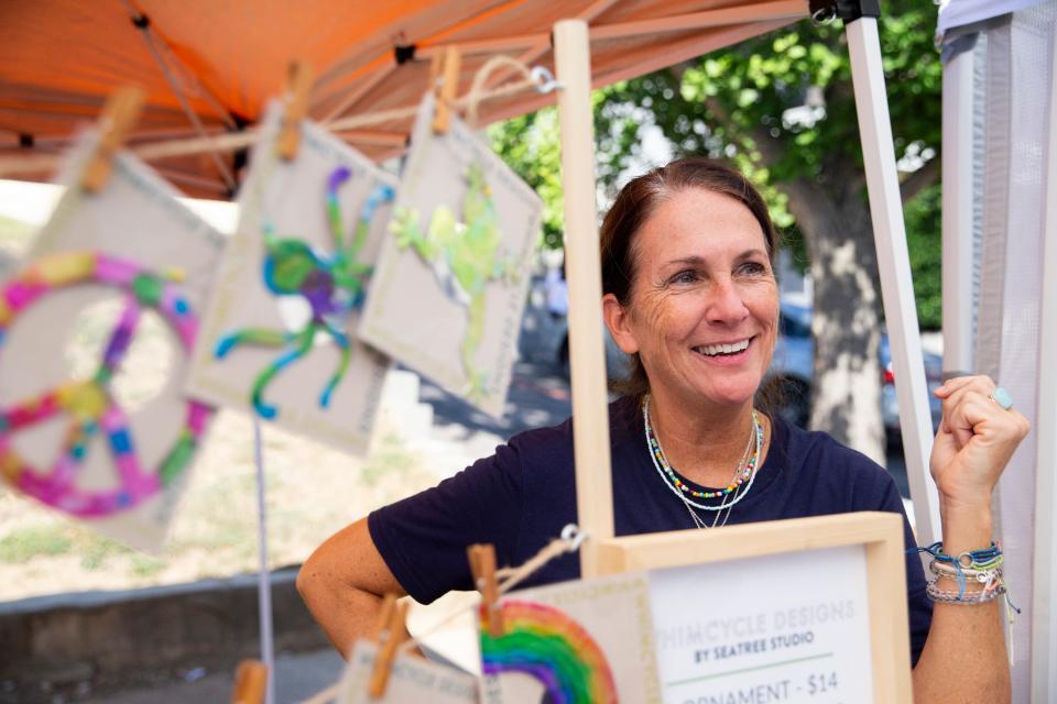 Dee Moore talks about ornaments she makes out of aluminum cans, known as Whimcycle Designs, with her daughter Grace Moore, who founded the company Seatree Studios, during the Cooper-Young Festival in Midtown Memphis, on Saturday, September 16, 2023.