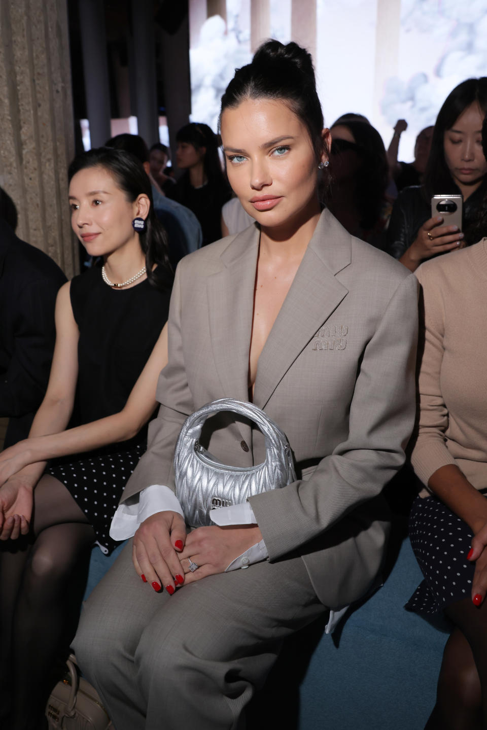 A closeup of Adriana sitting at a fashion show