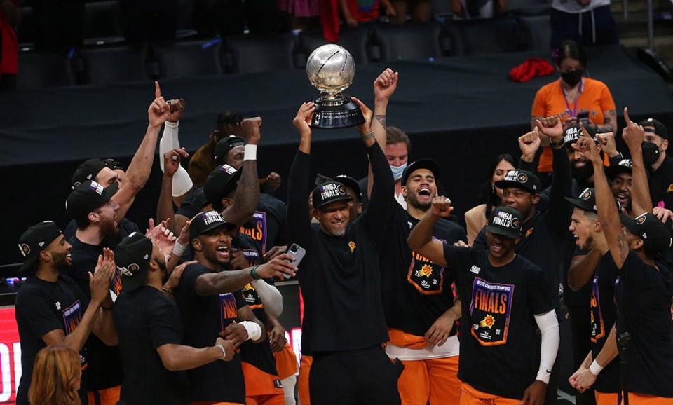 Phoenix Suns head coach Monty Williams hoists the Western Conference trophy after beating the LA Clippers in Game 6 at STAPLES Center on June 30, 2021.