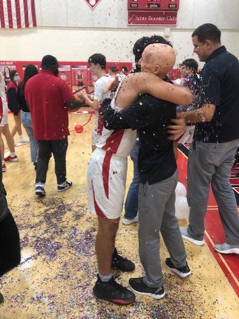 St. Andrew's junior guard Luke Sedaka (left) hugs coach John O'Connell after the Scots' 55-33 victory over Fort Lauderdale-Pine Crest on Friday night in Boca Raton.