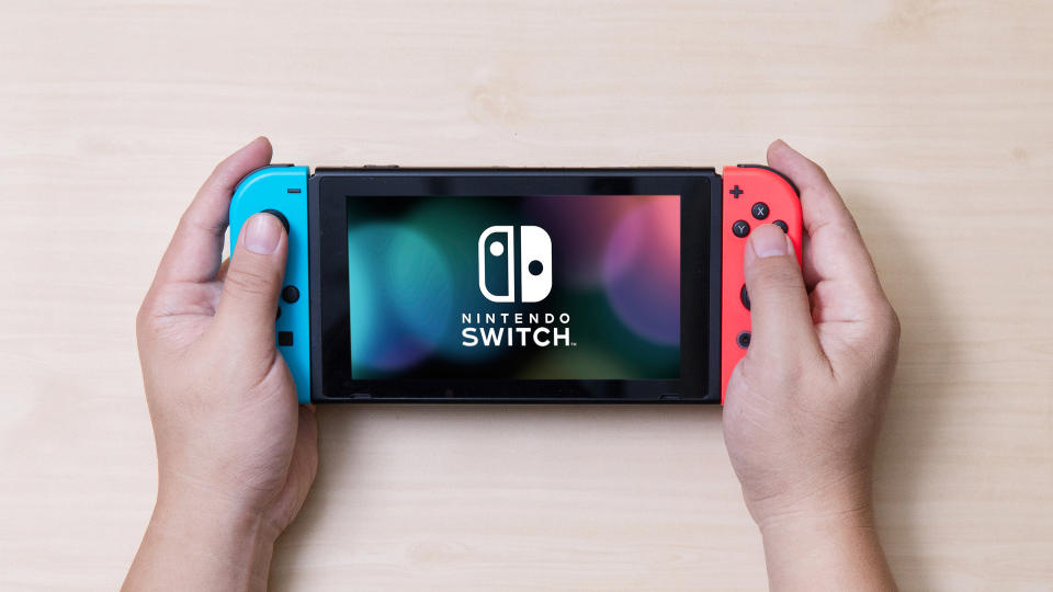 Man holding a Nintendo Switch