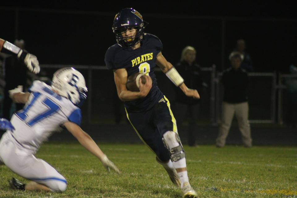 Pewamo-Westphalia junior quarterback Dylan May carries the football during a MHSAA Division 7 district semifinal game against Bath on Friday, Oct. 28, at Pirate Field in Westphalia. P-W defeated Bath, 47-12.