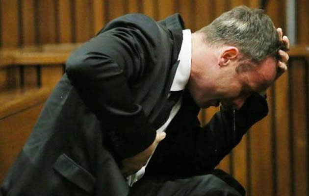 Star Paralympian Oscar Pistorius returned to the witness box to testify in his murder trial Tuesday, after an emotional first day that saw him issue a tearful apology to the victim's family. (AFP Photo)