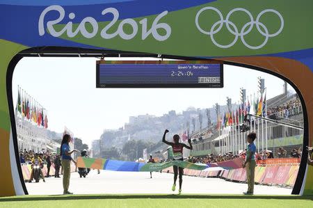 2016 Rio Olympics - Athletics - Final - Women's Marathon -Sambodromo - Rio de Janeiro, Brazil - 14/08/2016. Jemima Sumgong (KEN) of Kenya crosses the finish line to win the race REUTERS/Dylan Martinez