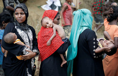 Rohingya refugees wait to receive aid in Cox's Bazar, Bangladesh, September 24, 2017. REUTERS/Cathal McNaughton