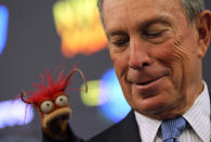 New York City Mayor Michael Bloomberg look over his shoulder to see the Muppet Pepe the King Prawn during a news conference on April 13, 2012 in New York City. NYC Mayor Michael Bloomberg and NYC and Co. announced today that the Muppets will act as New York City's official family ambassadors for the next year. The Muppets will will encourage family travel to New York City by highlighting the best ways for families to experience the city. (Photo by Justin Sullivan/Getty Images)