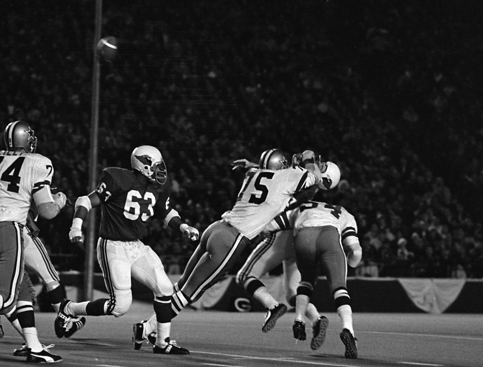Dallas Cowboys defenders Jethro Pugh (75) and Chuck Howley (54) sack St. Louis Cardinals quarterback Jim Hart in the first quarter, Nov. 16, 1970.