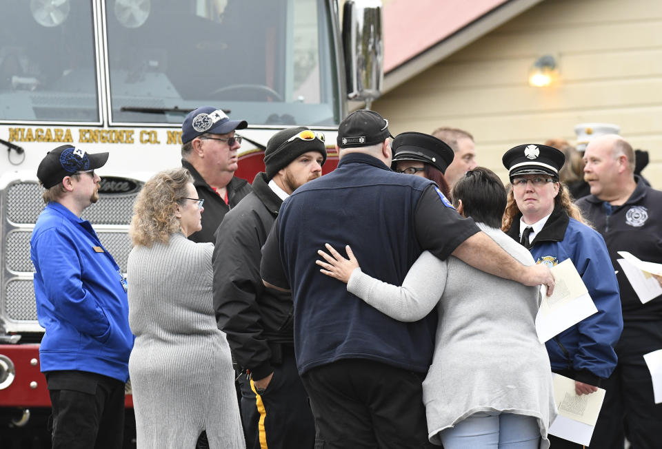 First responders wait for the start of the Reflections Memorial unveiling ceremony, on the one year anniversary of the Schoharie limousine crash that killed 20 people next to the Apple Barrel Restaurant Saturday, Oct. 5, 2019, in Schoharie, N.Y. (AP Photo/Hans Pennink)