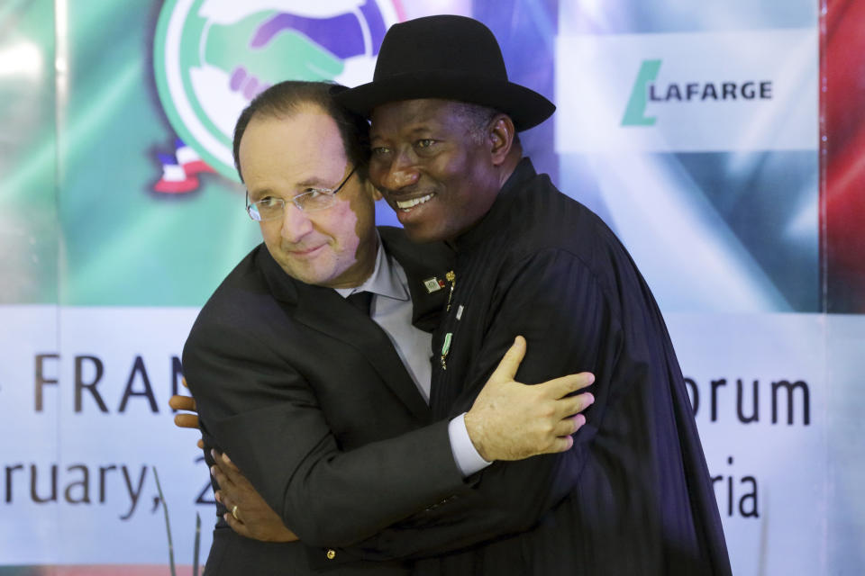 Nigerian President Goodluck Jonathan, right, embraces French President Francois Hollande after they opened the Nigeria-France business forum in Abuja, Nigeria, Thursday, Feb. 27, 2014. Hollande is in Nigeria for a one-day official visit. (AP Photo/Philippe Wojazer, Pool)