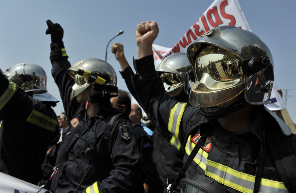 Firefighters shout slogans during a protest in the northern Greek port city of Thessaloniki, Saturday, Sept. 8, 2012. Greece, in the grip of a severe recession for the fifth straight year, is still struggling to avoid bankruptcy by imposing harsh austerity measures, including wage and pension cuts. Unemployment has soared to nearly a quarter of the workforce. (AP Photo/Nikolas Giakoumidis)