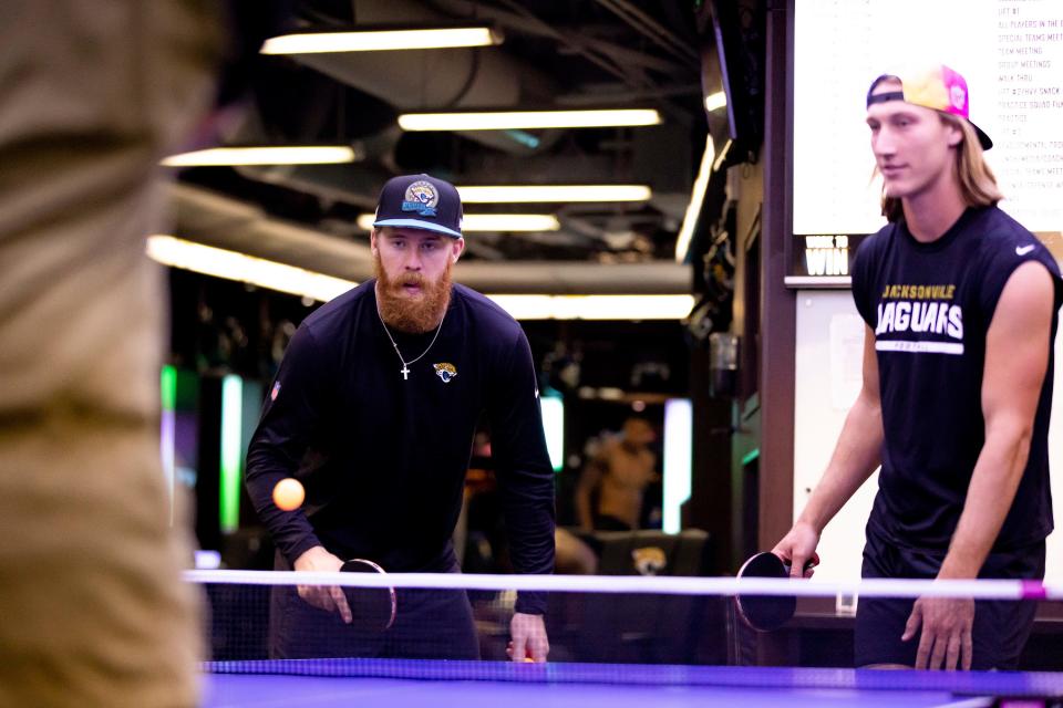 Jacksonville Jaguars starting quarterback Trevor Lawrence, right, and backup QB C.J. Beathard, play table tennis in the team locker room after practice at TIAA Bank Field.