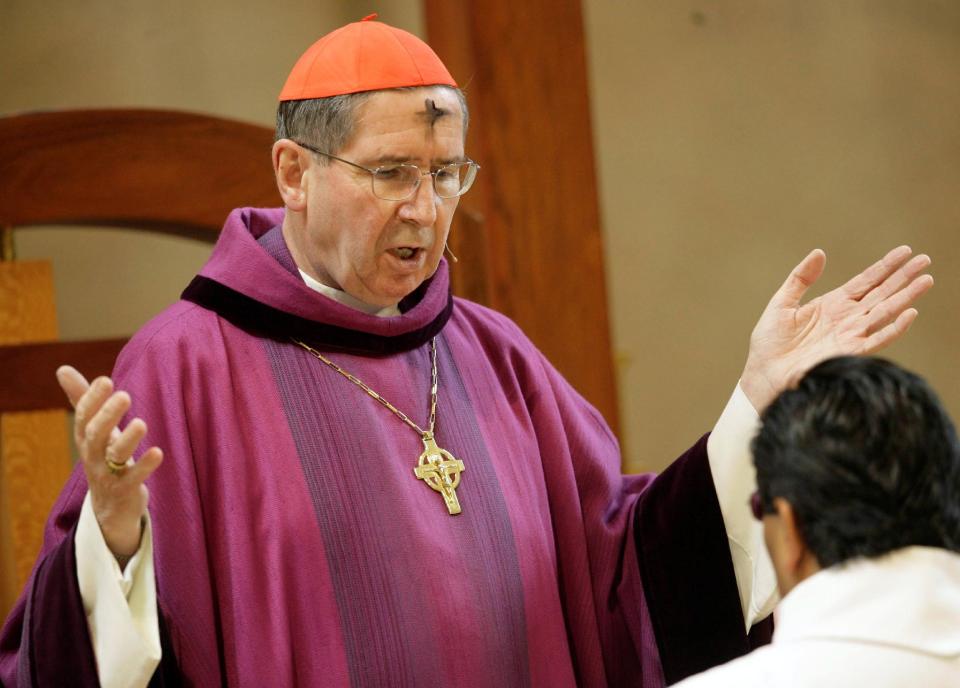 FILE - In this Feb. 6, 2008 file photo, Cardinal Roger Mahony officiates during Ash Wednesday services at the Cathedral of Our Lady of the Angels in Los Angeles. The Roman Catholic Archdiocese of Los Angeles will pay $13 million to settle 17 clergy abuse lawsuits, including 11 that involve a visiting Mexican priest who fled prosecution and remains a fugitive more than 25 years later, plaintiffs' attorneys said Tuesday Feb. 18, 2014. (AP Photo/Nick Ut, File)