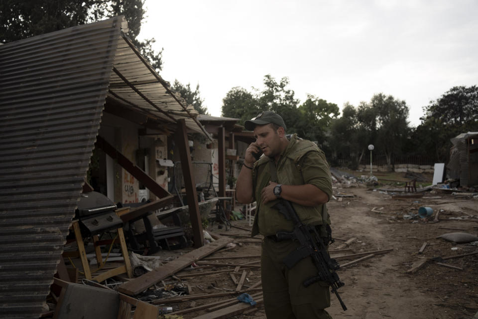 An Israeli soldier makes a call during a visit by former New Jersey Governor Chris Christie to Kibbutz Kfar Azza, near the Israel-Gaza border, the site of an Oct. 7 massacre by Hamas, Sunday, Nov. 12, 2023. (AP Photo/Maya Alleruzzo)