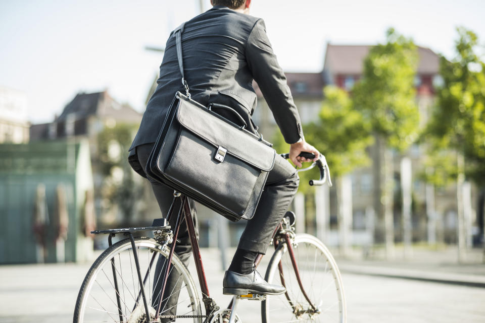 Young businessman riding bicycle