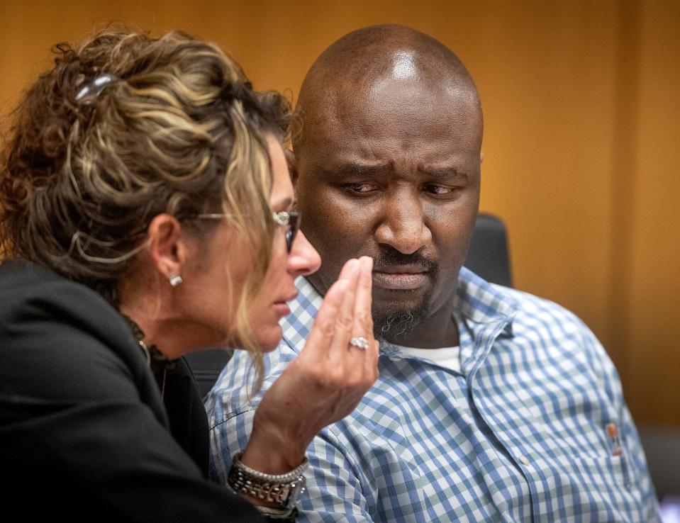 Marcelle Waldon speaks with defense attorney Debra Tuomey on the first day of testimony in his first-degree murder trial.