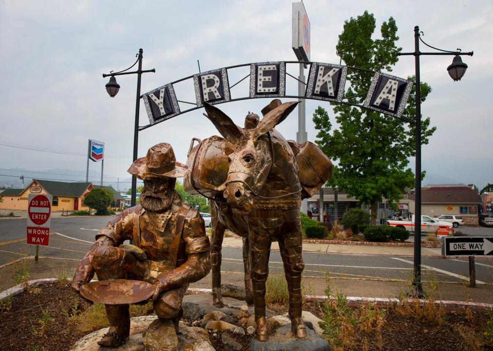 An art installation in downtown Yreka shows a miner crouching to pan for gold with his mule behind him, paying to tribute to California's historic Gold Rush.