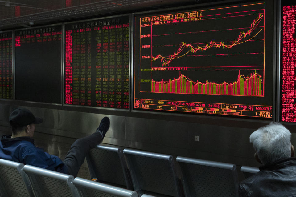 Investors monitor stock prices at a brokerage in Beijing Thursday, Jan. 16, 2020. Share prices are mixed in moderate trading in Asia after the U.S. and China signed a preliminary trade agreement that investors hope will bring better relations between the two biggest economies. (AP Photo/Ng Han Guan)