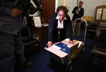 A U.S. Government Printing Office employee delivers copies of President Barack Obama's Fiscal Year 2015 Budget to The House Budget Committee on Capitol Hill in Washington, March 4, 2014. REUTERS/Yuri Gripas