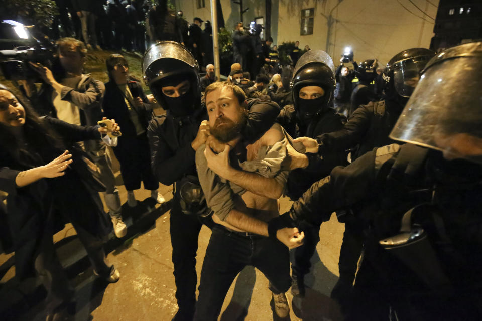 Police officers detain a protestor during a demonstration outside the parliament building during a protest against "the Russian law", similar to a law that Russia uses to stigmatize independent news media and organizations seen as being at odds with the Kremlin, in Tbilisi, Georgia, April 16, 2024. (AP Photo/Zurab Tsertsvadze)