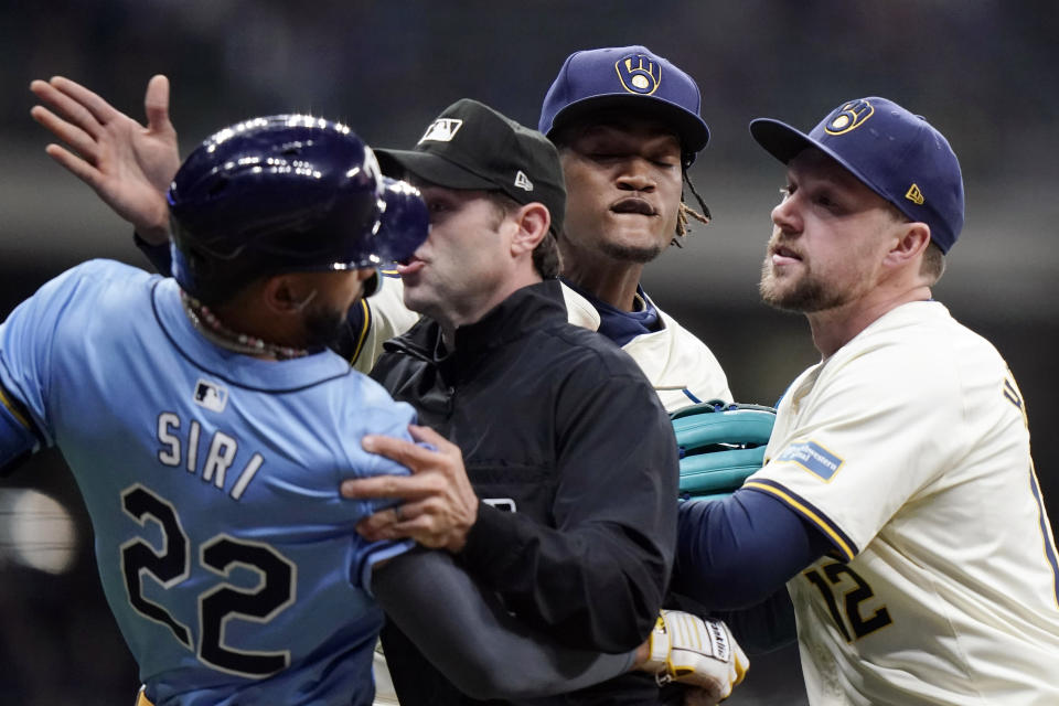 Tampa Bay Rays' Jose Siri (22) fights with Milwaukee Brewers' Abner Uribe, middle, during the eighth inning of a baseball game Tuesday, April 30, 2024, in Milwaukee. (AP Photo/Aaron Gash)