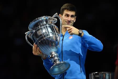 Tennis - Barclays ATP World Tour Finals - O2 Arena, London - 15/11/15 Men's Singles - Novak Djokovic of Serbia holds the trophy for finishing Number One ATP Men's Tennis Player in the World for 2015 following his match Action Images via Reuters / Tony O'Brien Livepic