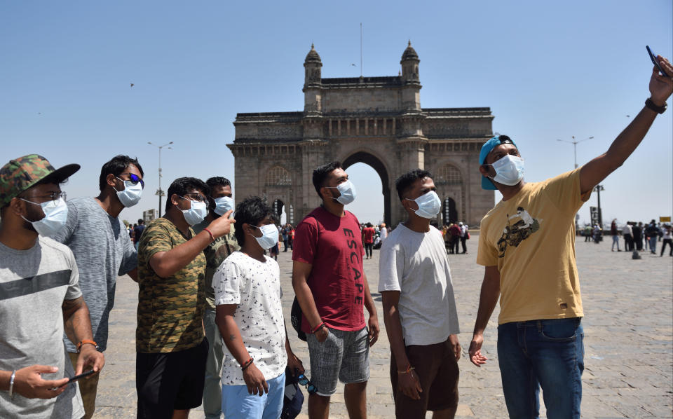 People are seen wearing protective mask as a precaution from Coronavirus at Gateway of India in Mumbai.