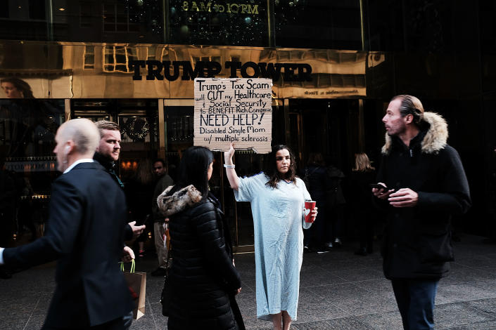 <p>Rosary Solimanto, who has multiple sclerosis and fears for her finances, holds a protest outside of Trump Tower over the Republican administration’s proposed tax cut which many economists predict will benefit the wealthy at the expense of the poor and middle class on Nov. 30, 2017 in New York City. (Photo: Spencer Platt/Getty Images) </p>